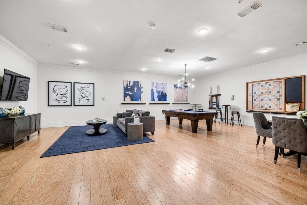 A pool table in the middle of the clubhouse entertainment lounge at Marquis at The Cascades in Tyler, TX.