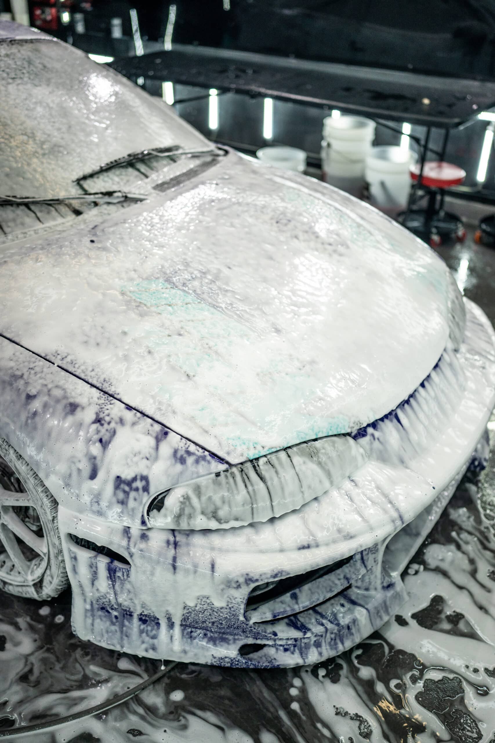 A car covered in foam is sitting on a table.