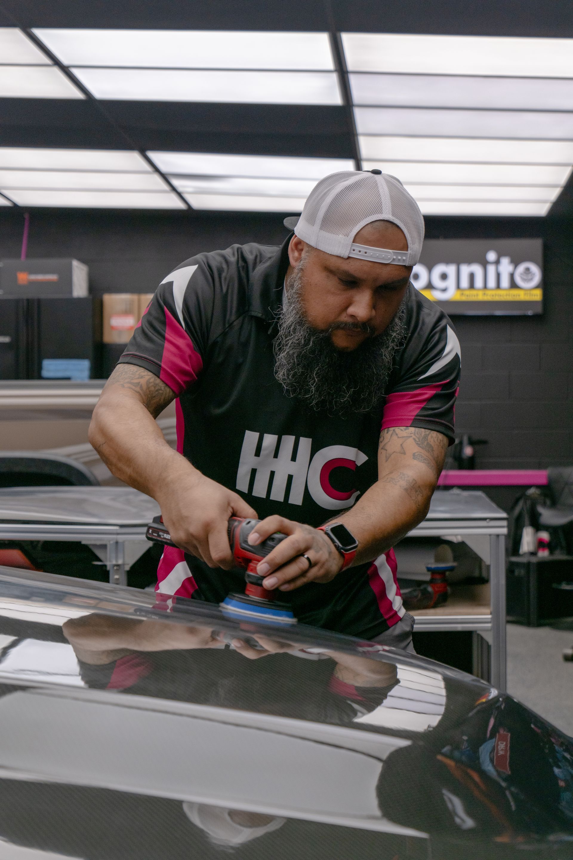 Technician performing paint correction on the carbon fiber hood of a Cadillac CTS-V using a dual action polisher near Temple, TX.