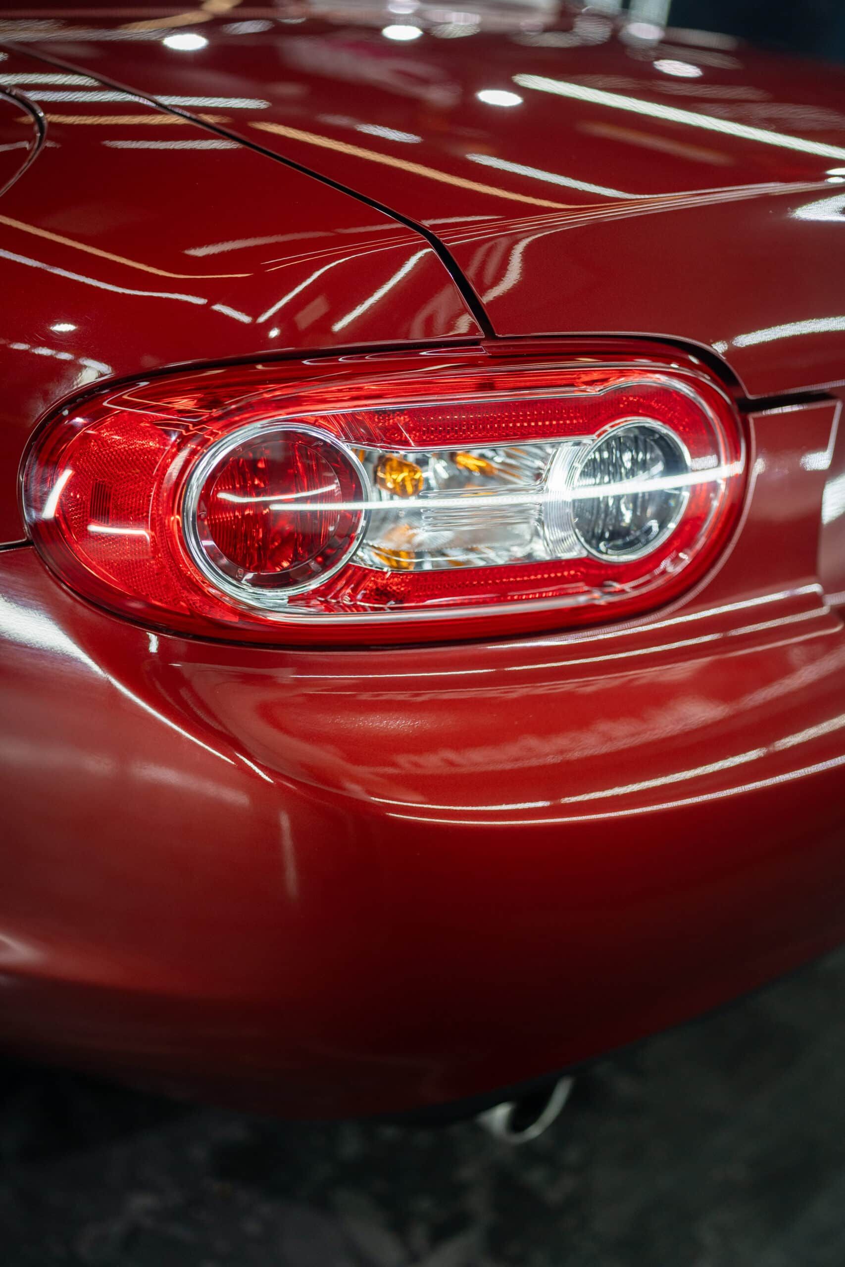 A close up of a red car 's tail light.