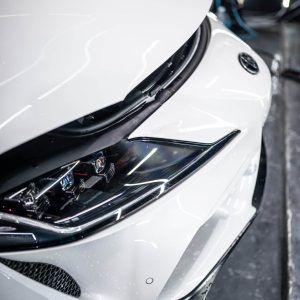 A close up of the front of a white car.