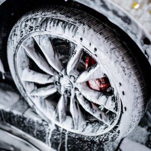 A close up of a car wheel covered in foam.