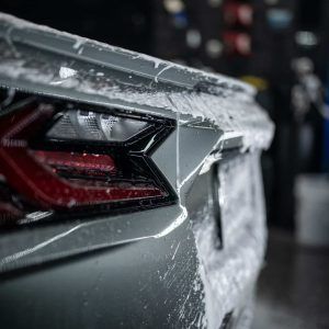 The back end of a lamborghini aventador is covered in foam.