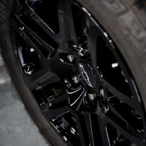 A close up of a black wheel on a car.