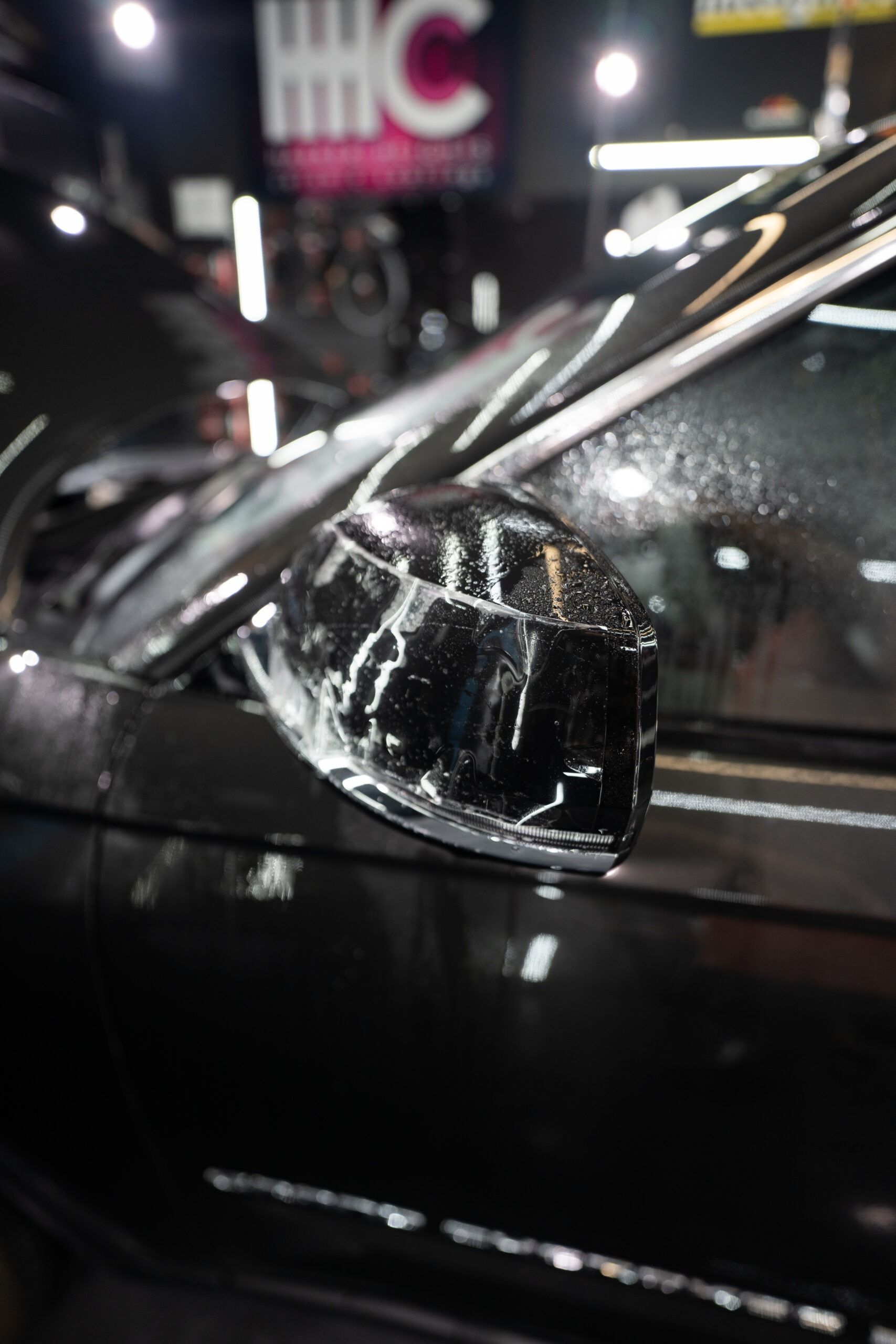 A close up of a car 's side mirror and windshield