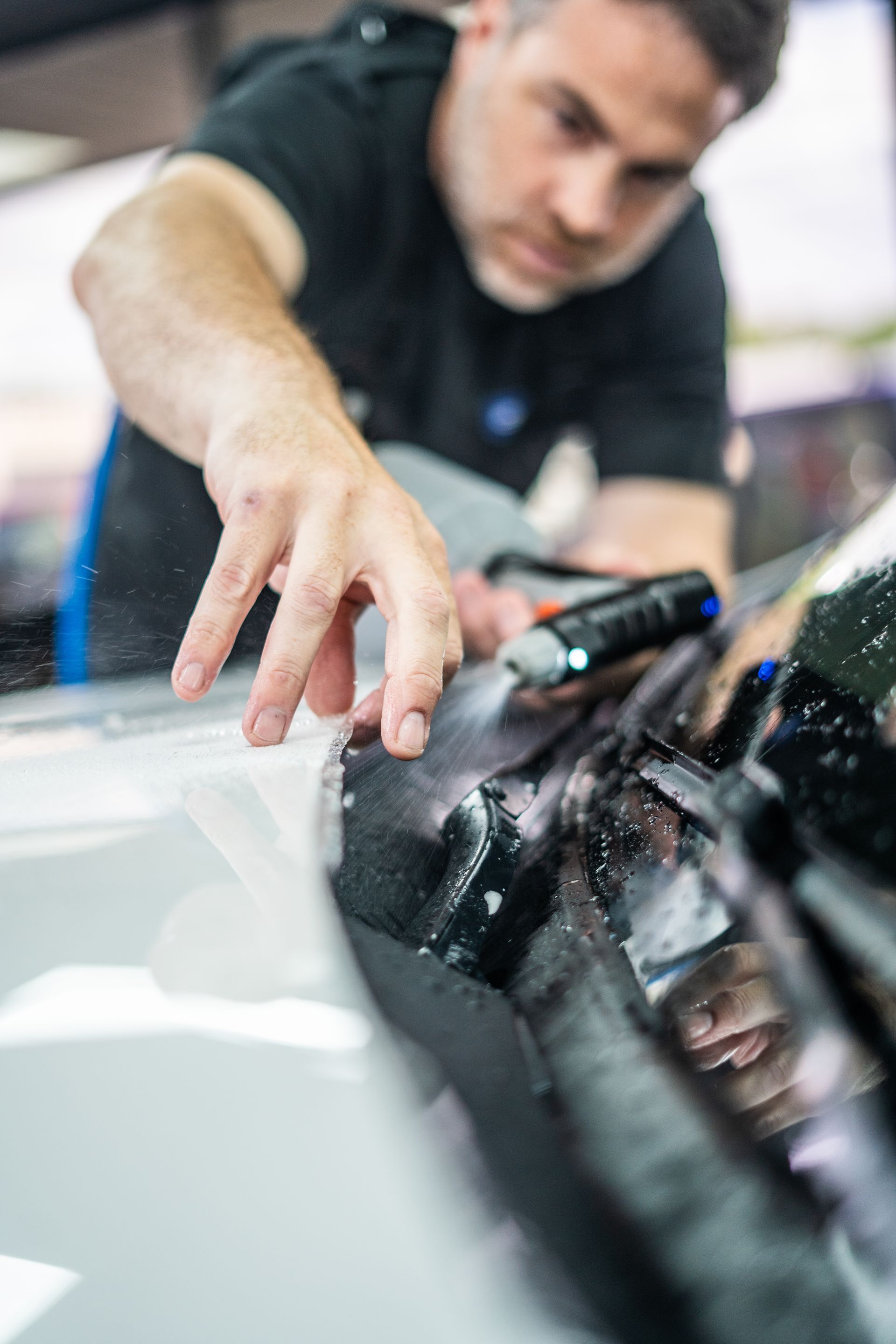 A man is working on a car in a garage.