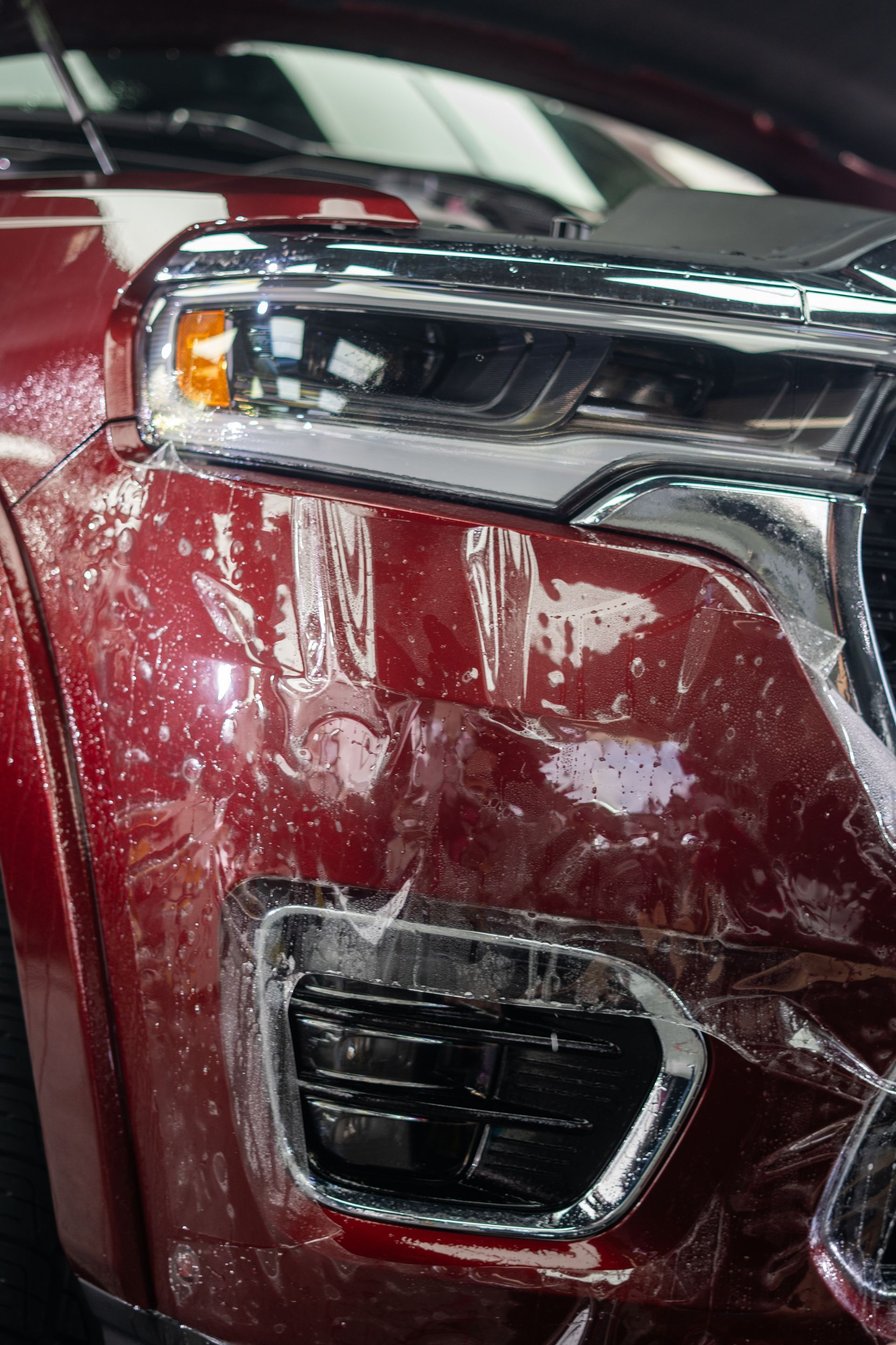A close-up of a red car with a paint protection film film on it.