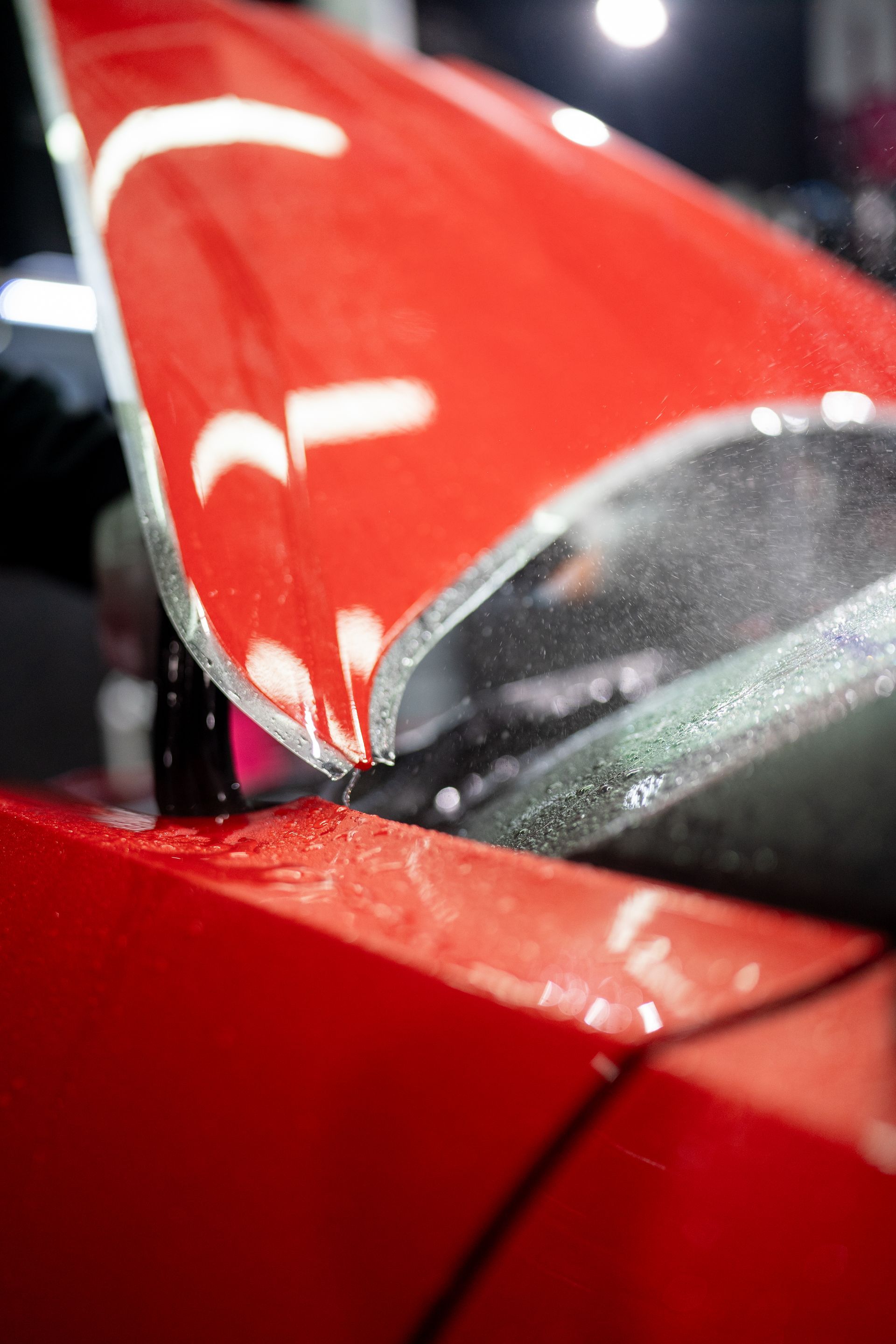 A close up of a red car with the hood open.