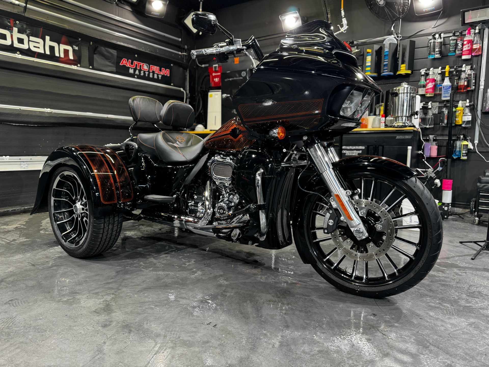 A motorcycle with three wheels is parked in a garage.