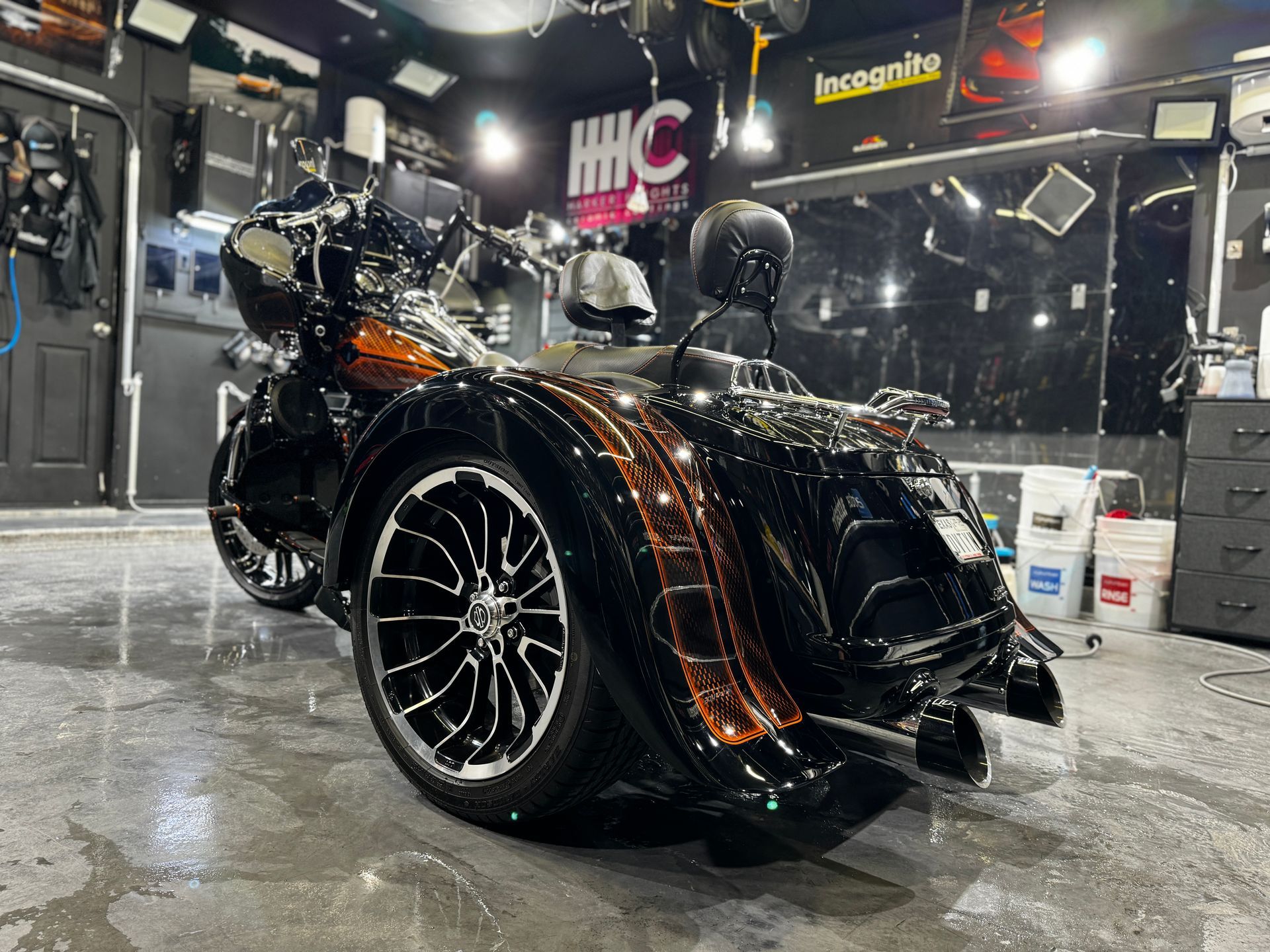 A motorcycle with three wheels is parked in a garage.