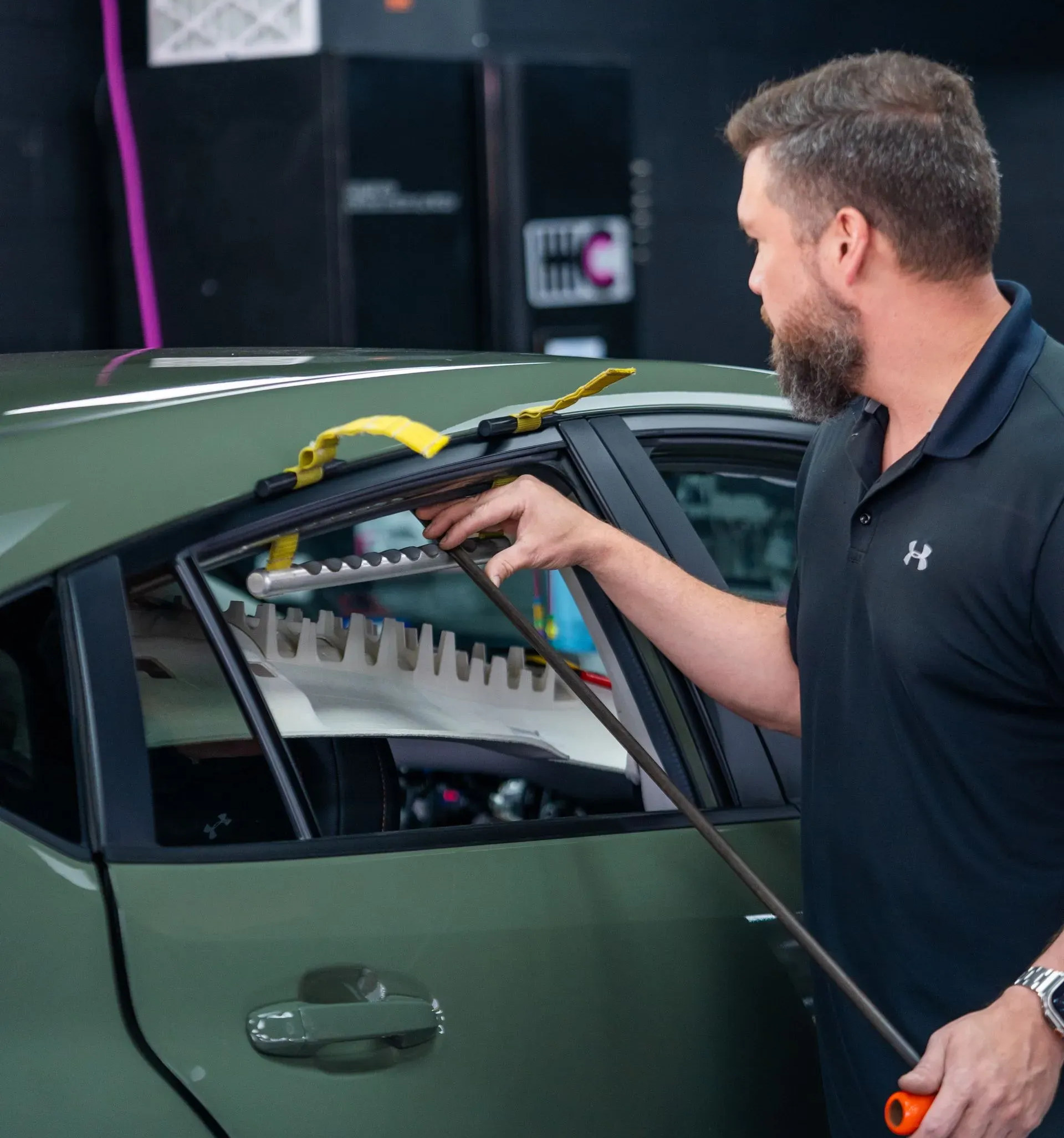 A close up of a car 's tail light being worked on