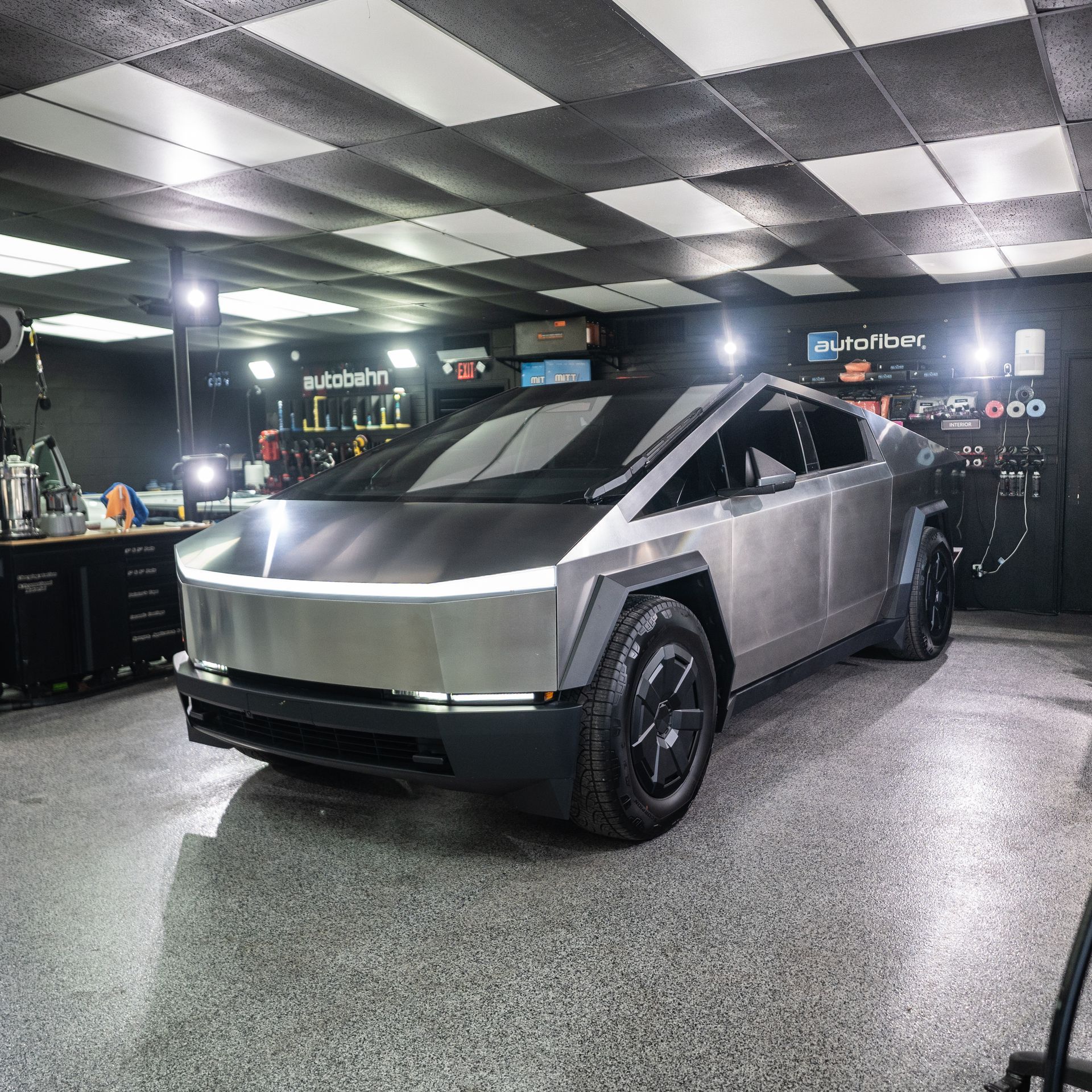 A tesla cybertruck is parked in a garage