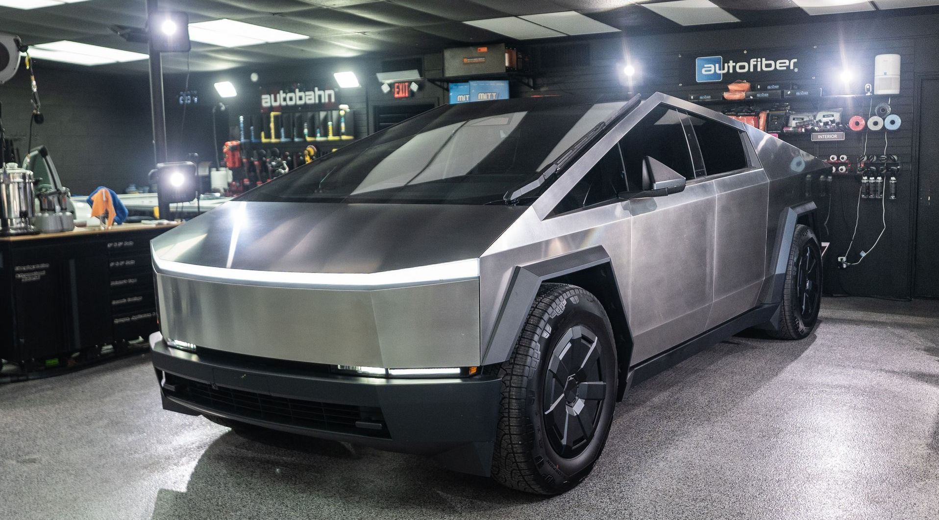 A tesla cybertruck is parked in a garage.