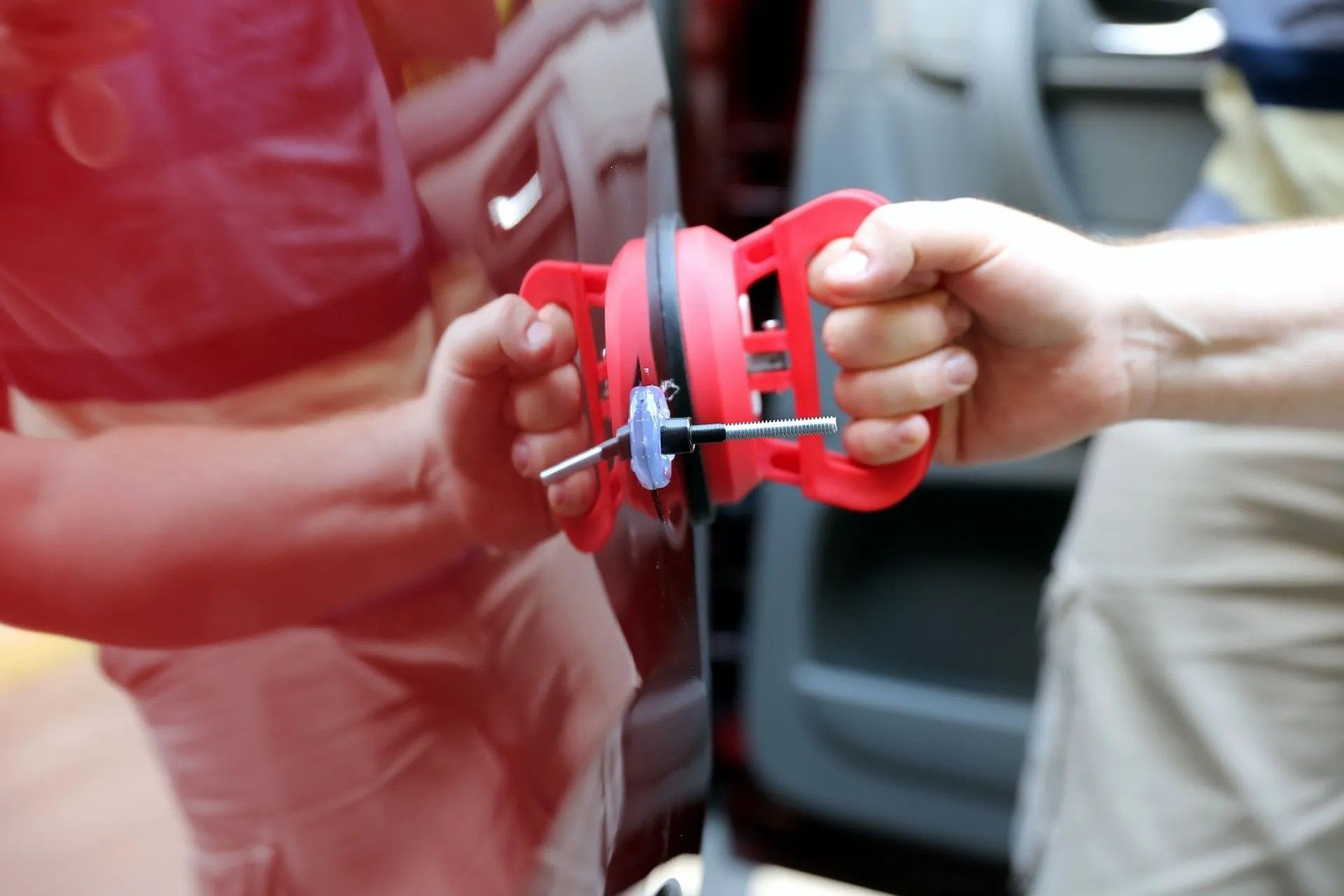 A close up of a car 's tail light being worked on