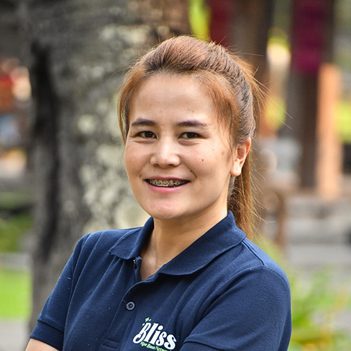 A woman wearing a blue shirt that says bliss
