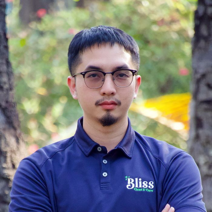 A woman wearing a blue shirt that says bliss