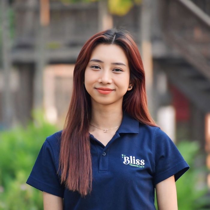 A woman wearing a blue shirt that says bliss