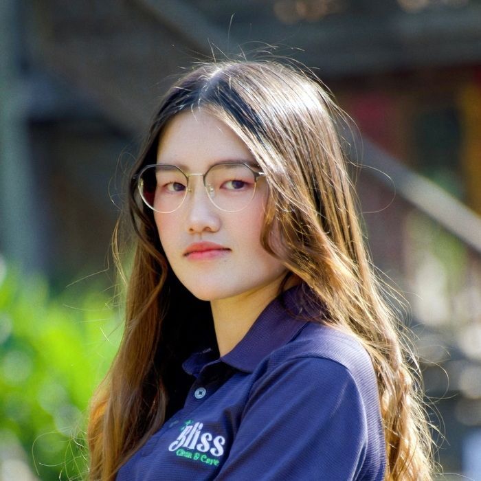 A woman wearing a blue shirt that says bliss