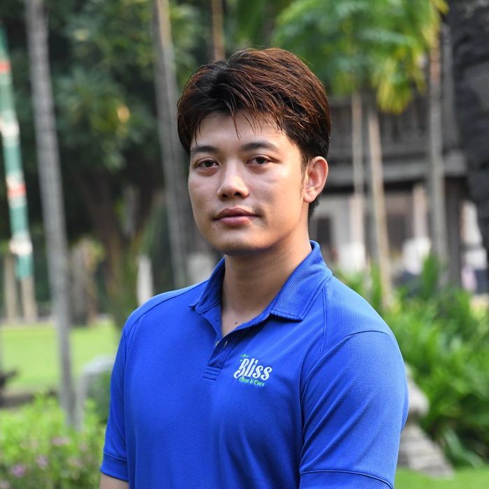 A woman wearing a blue shirt that says bliss