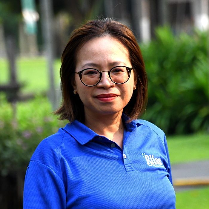 A woman wearing a blue shirt that says bliss