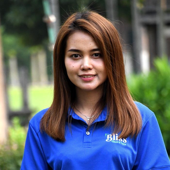 A woman wearing a blue shirt that says bliss