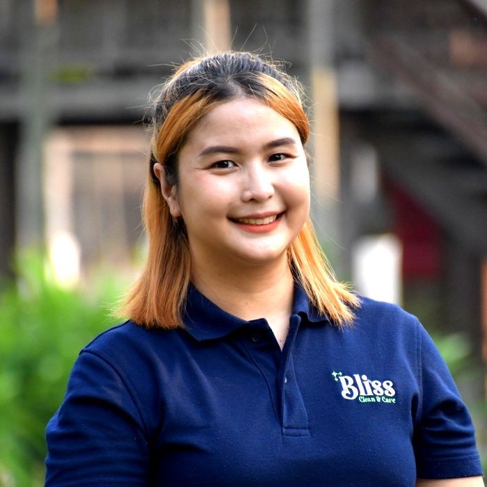 A woman wearing a blue shirt that says bliss