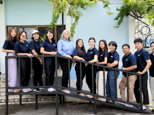A group of people standing on a ramp in front of a building