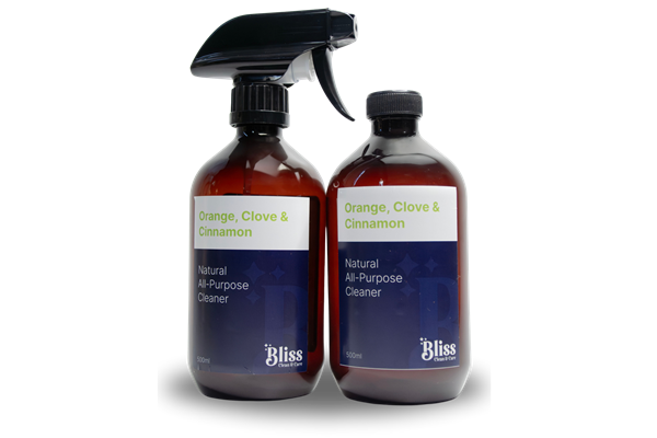Two bottles of bliss orange clove and cinnamon on a white background