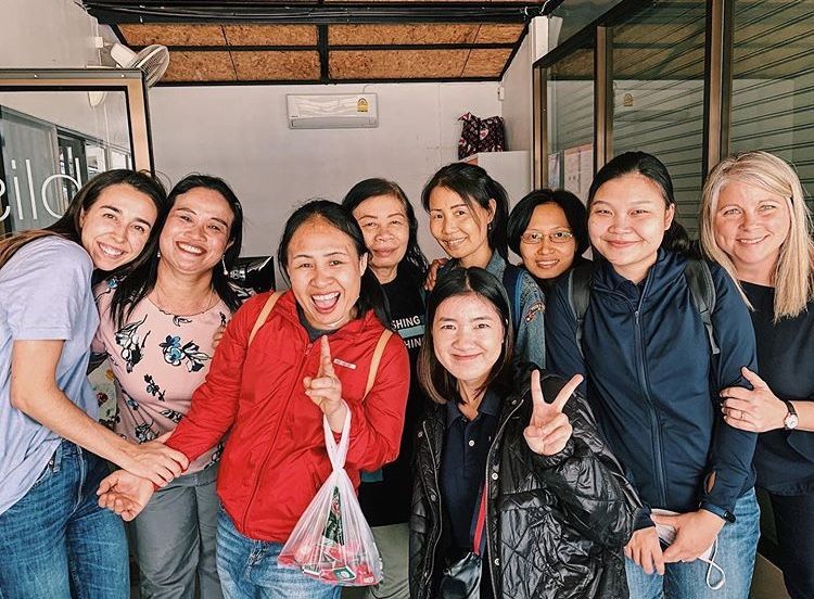 A group of women are posing for a picture together.