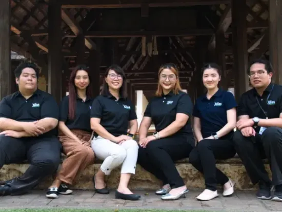 A group of women posing for a picture with one wearing a shirt that says bb