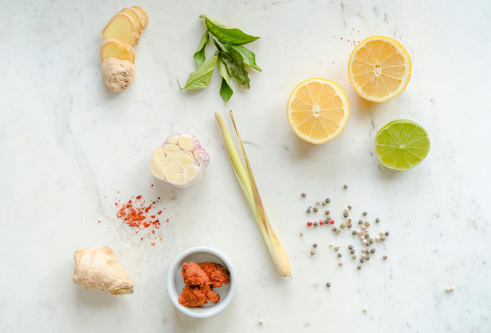 A variety of vegetables and spices are laid out on a table