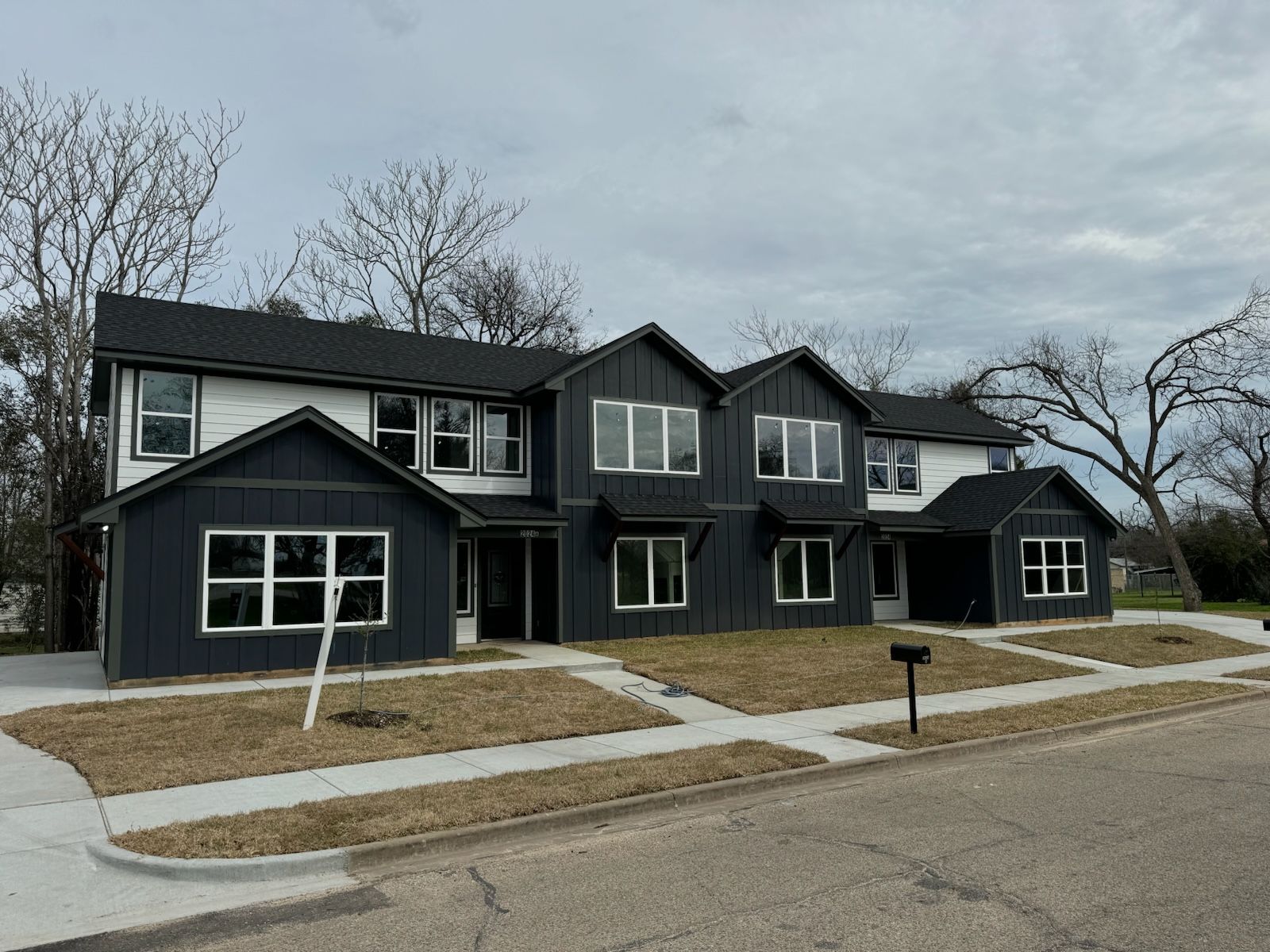 Looking up at a group of skyscrapers against a blue sky.
