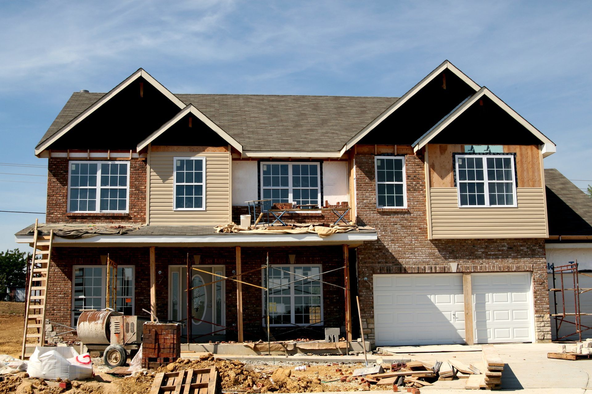 A modern house with a balcony and a glass railing.