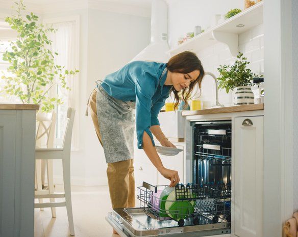 Woman Using a Dishwasher Machine — Jacksonville, FL — Appliance Doctors