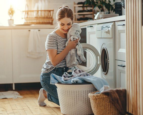 Woman Using a Washing Machine — Jacksonville, FL — Appliance Doctors