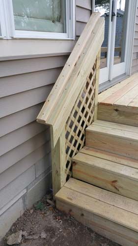 Wooden deck stairs with lattice railing.