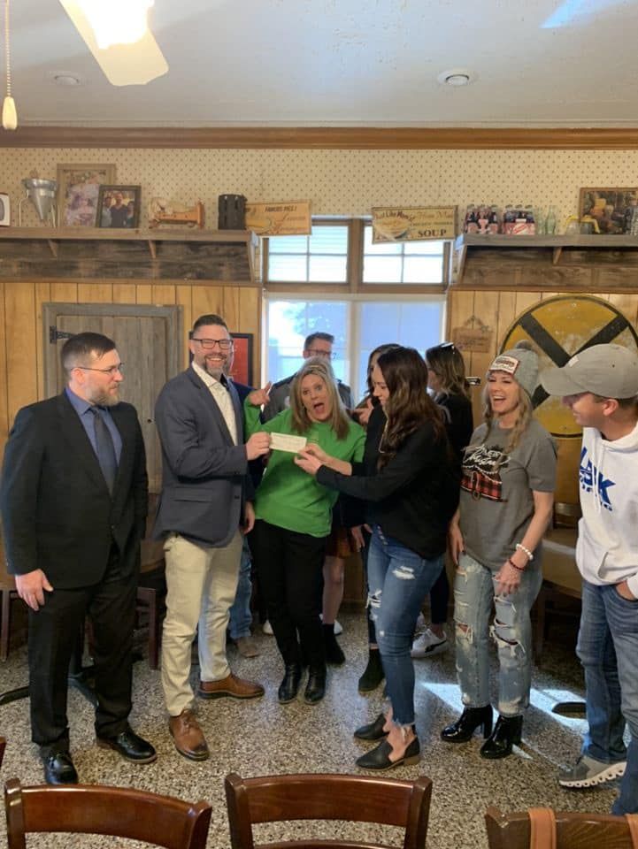 Happy Team Getting Donation — Lubbock, TX — Referral Hub 2.0