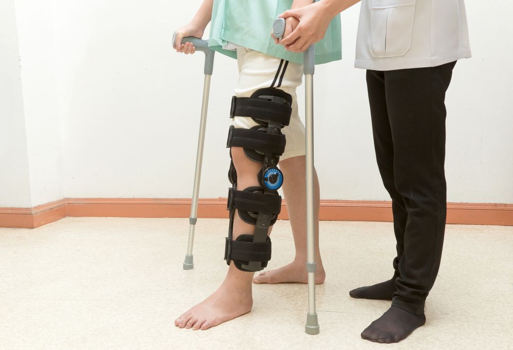 Person using crutches and knee brace, assisted by someone, indoors
— Bespoke Legal Group In Northern, NSW