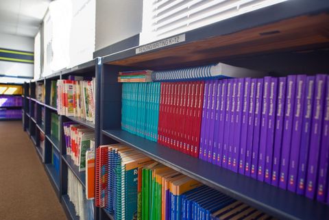 a library filled with lots of books on shelves .