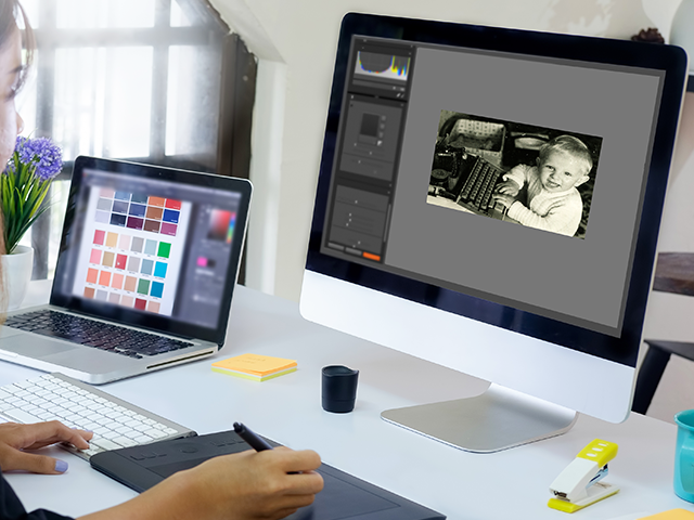 Designer working on old photograph on desktop