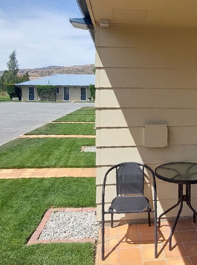 A kitchen with a sink , microwave , and refrigerator.