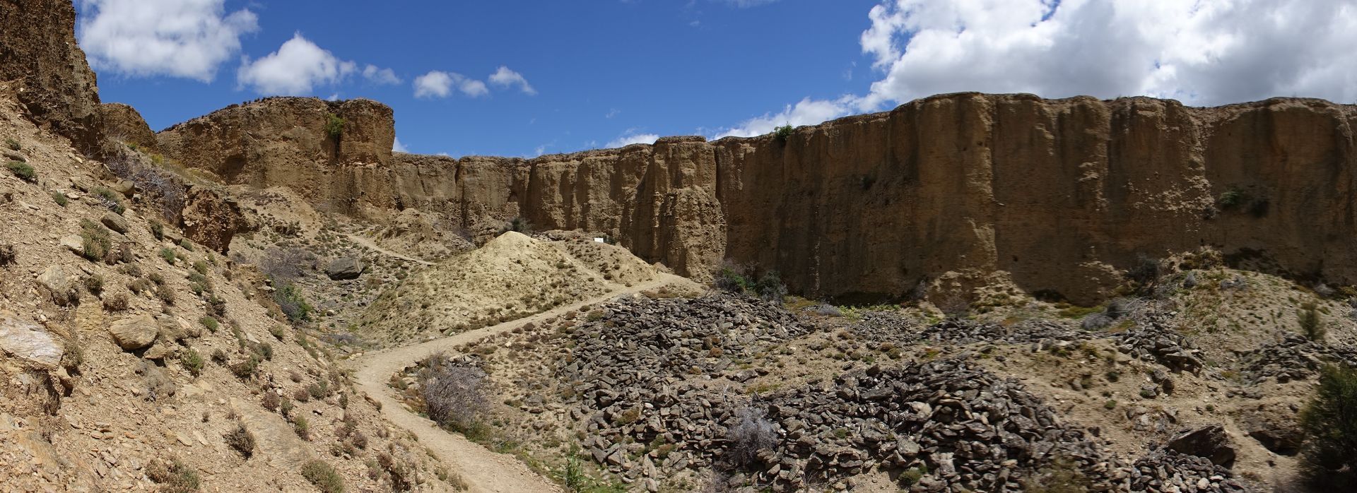 Hikers exploring the rugged terrain at Bannockburn Sluicings Walk, surrounded by remnants of gold mining