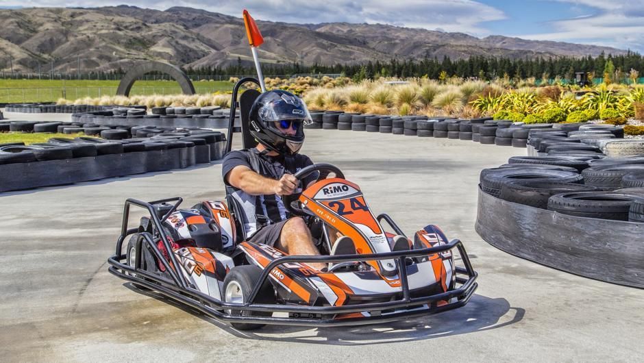 People racing go-karts on a track, leaning into turns with determination and excitement