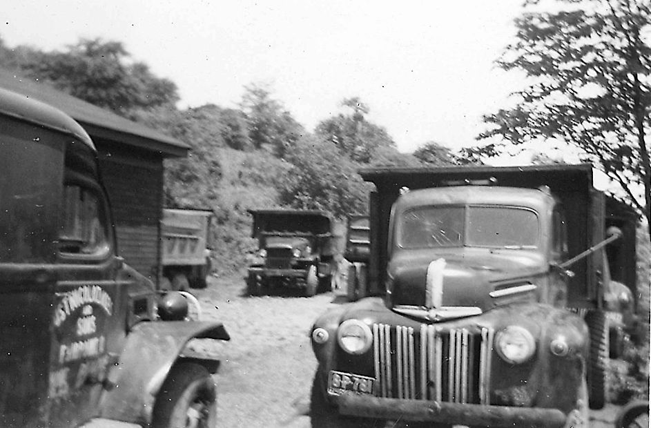 A black and white photo of a ford truck