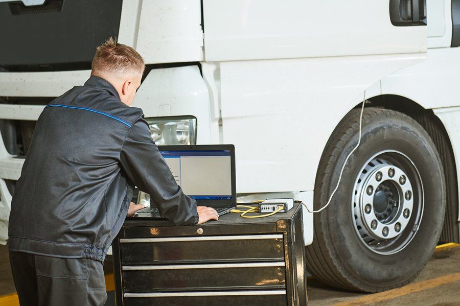 a mechanic using a laptop