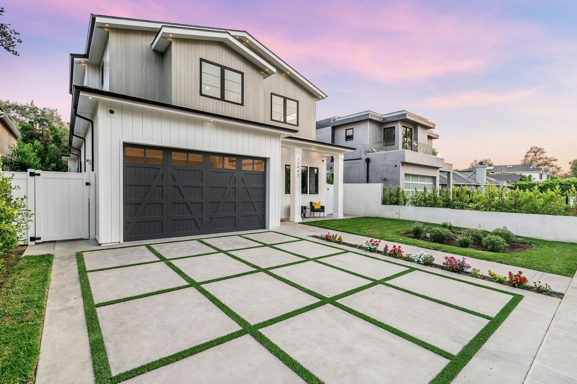 A woman is walking down a street in front of a row of houses