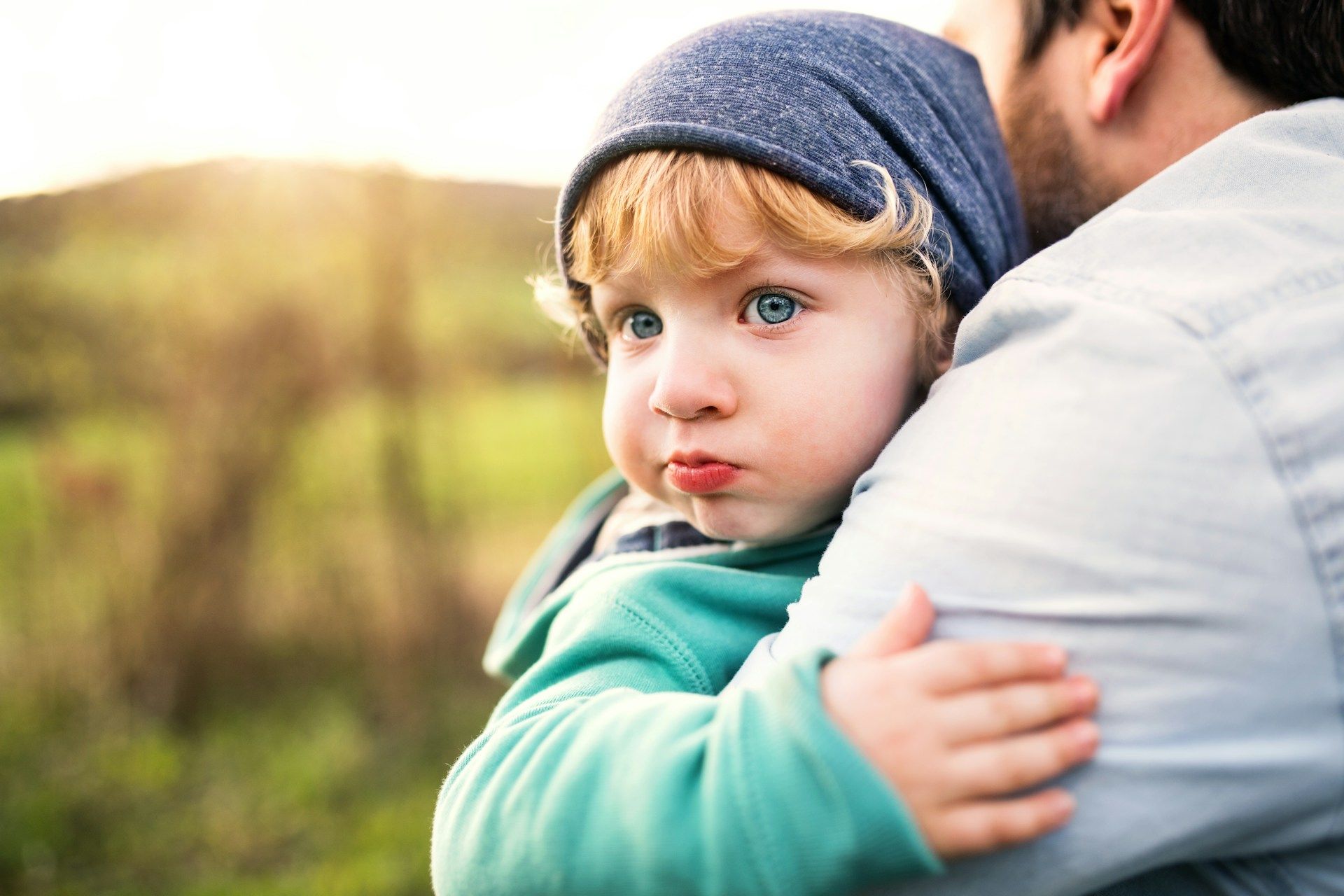 A woman is walking down a street in front of a row of houses