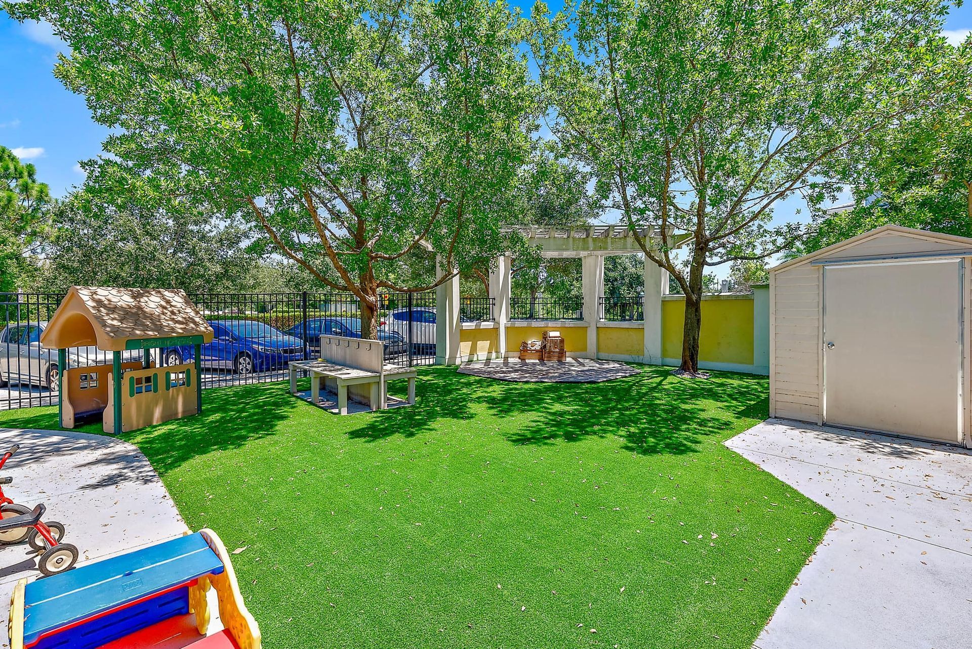 A playground with a house and a slide in the middle of it