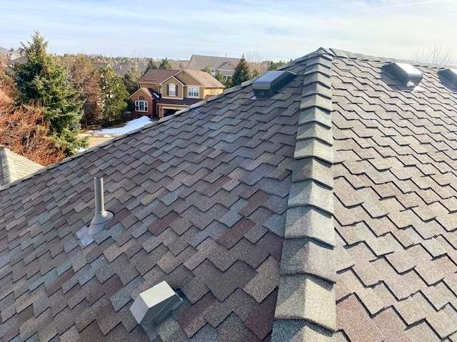 A close up of a roof with a lot of shingles on it.