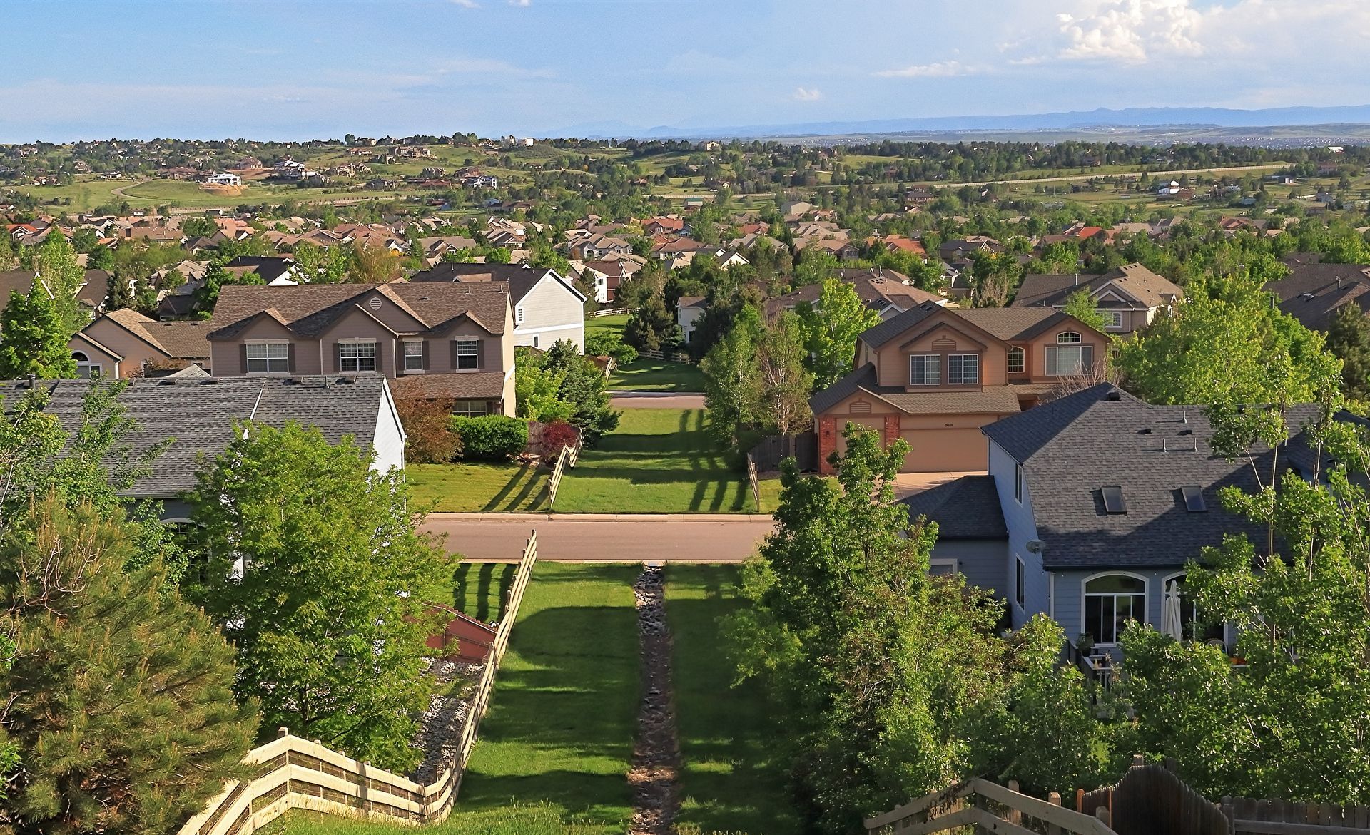 An aerial view of a residential area with houses and trees